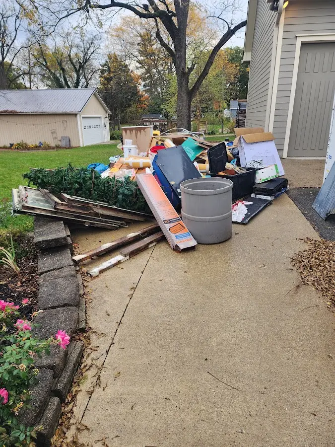 Dumpster being loaded with debris for Estate Cleanout Dumpster Rental in Troy